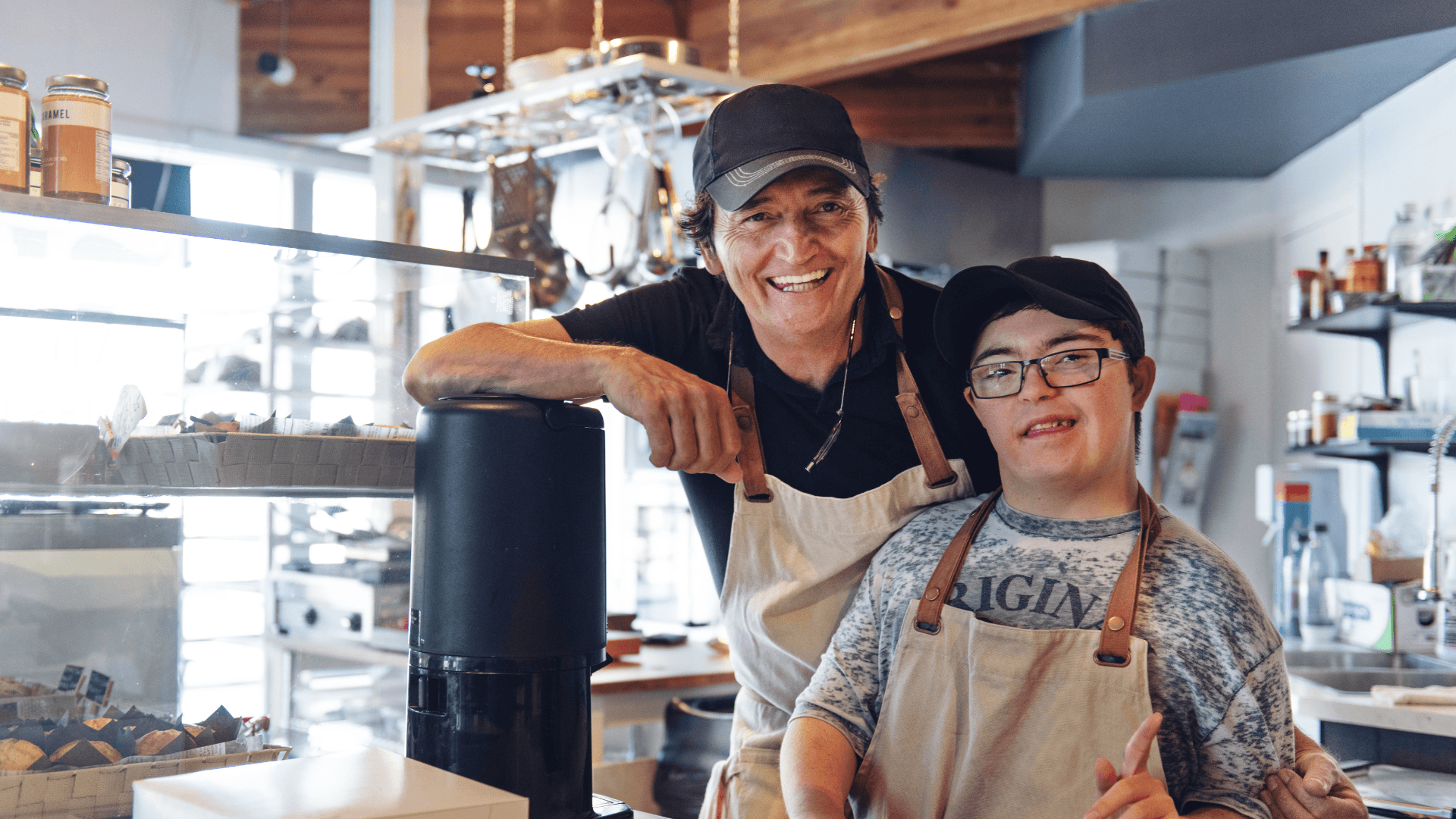 Two small business team members smiling inside their shop